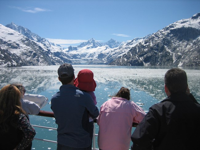 Family looking at a glacier that is off in the distance.