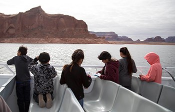 Kids look at Lake Powell scenery from top deck of tour boat