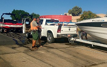 Ranger speaks to visitor trailering boat at top of launch ramp
