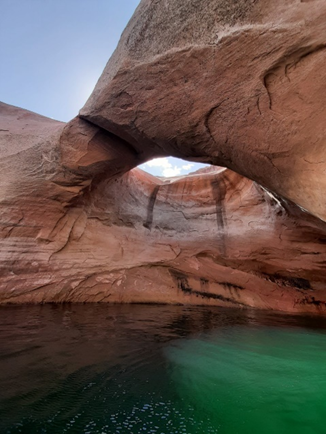 Natural sandstone ach over a desert lake