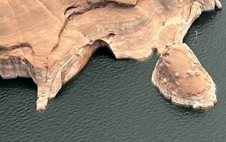 Aerial view of a sandstone canyon and desert lake.