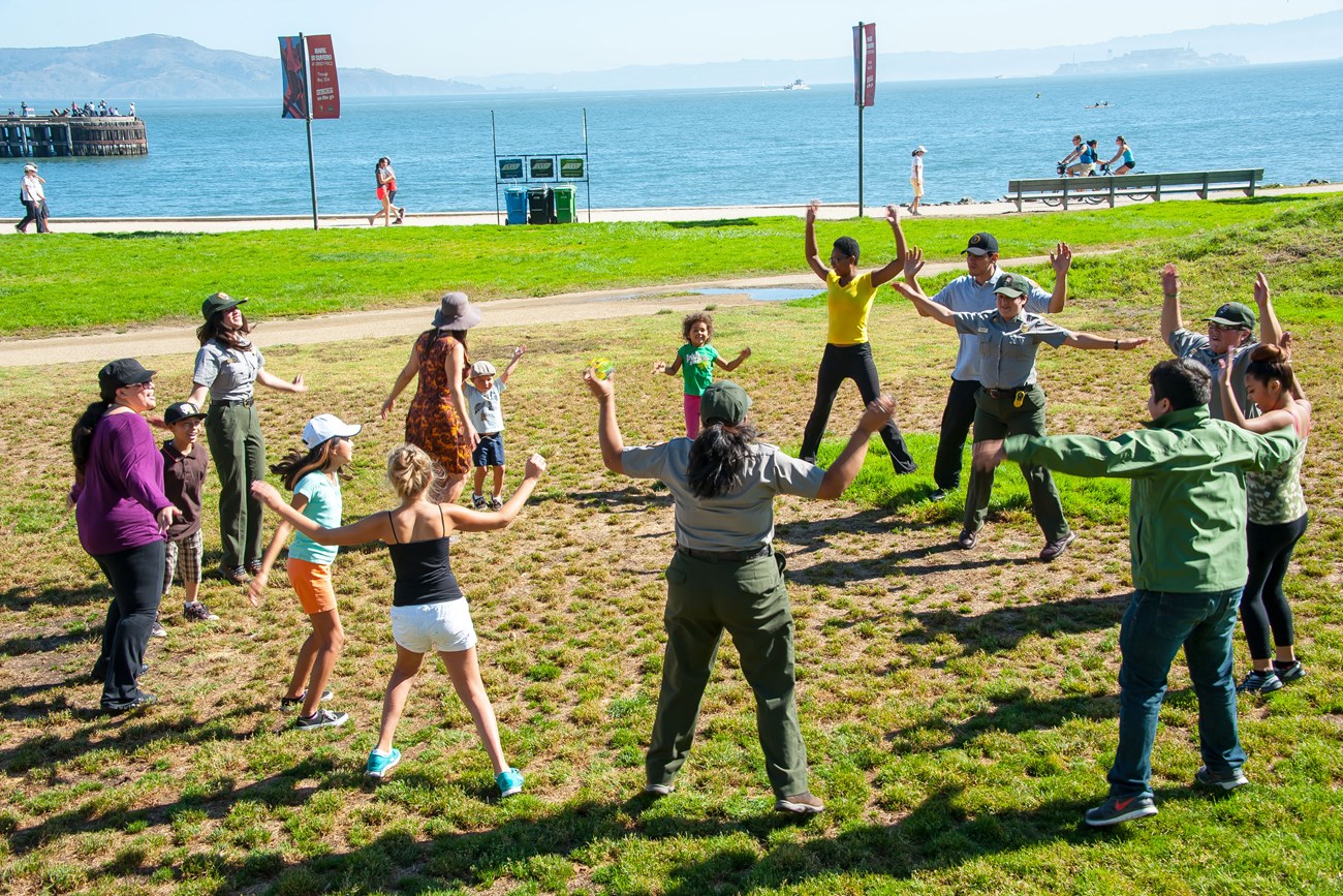People do jumping jacks on crissy field grounds