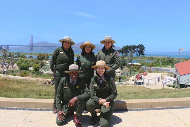 GOGA Education Park Rangers standing in front of the Outpost playground in the Presidio's Tunnel Tops.