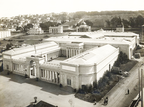 wide, formal building with rows of columns and open interior courtyard