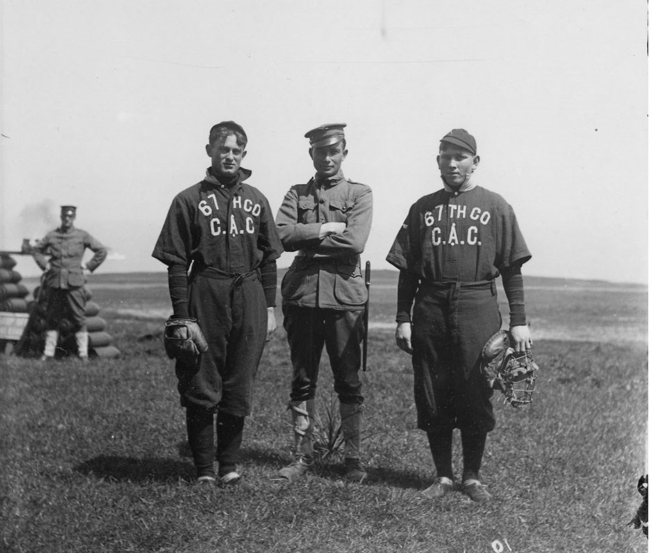 soldiers in old fashioned baseball uniforms holding catcher's mitts