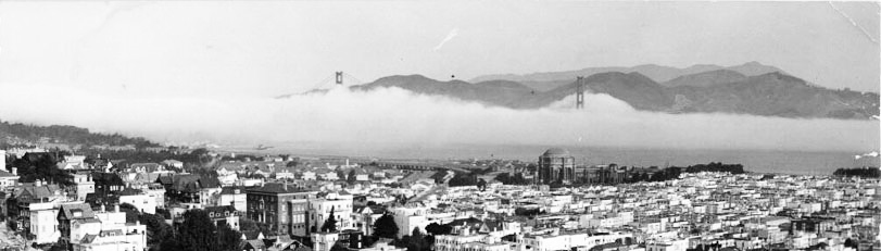 compact city blocks with fog and water in background