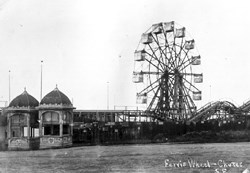 view of Ferris Wheel and wooden stands, with rail road tracks