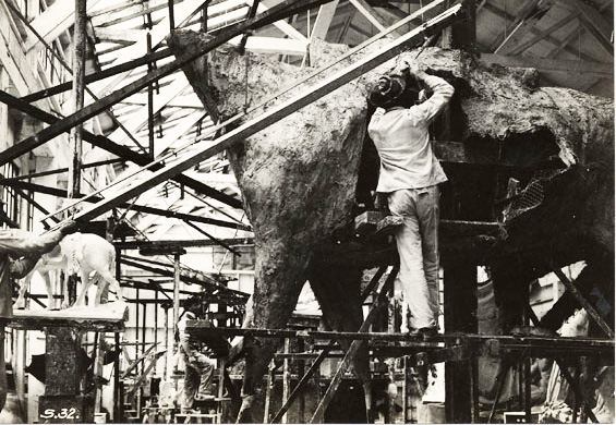 workers on scaffolding creating a statue