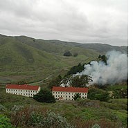 Smoke rising from a pile burn at Fort Barry in the Marin Headlands