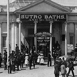 black and white photo of crowd coming out of "sutro baths and museum"