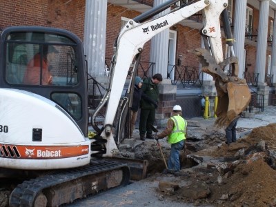 Excavation at Fort Jay.  Archaeological Consultant Linda Stone and park rangers supervise construction work at Fort Jay.