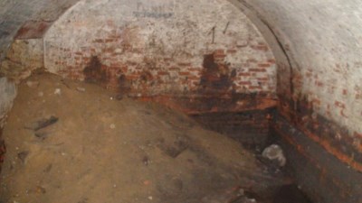 Inside the underground chamber.  Note the rubble fill pile used when the room was sealed off sometime in the 1930s.