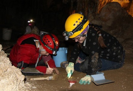 Kids cleaning cave floor