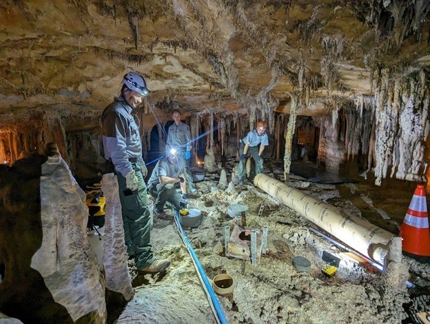 people with construction materials in decorated cave room