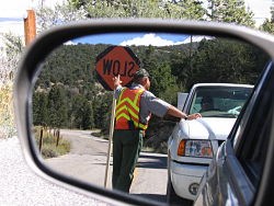 Maintenance worker holds back traffic for construction