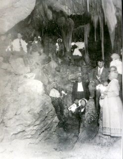 people standing in cave