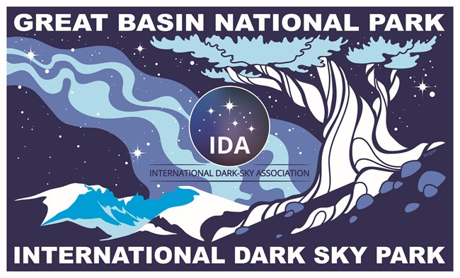 Blue sign on a field of stars with bristlecone and mountains with text "Great Basin National Park" and "International Dark Sky Park"