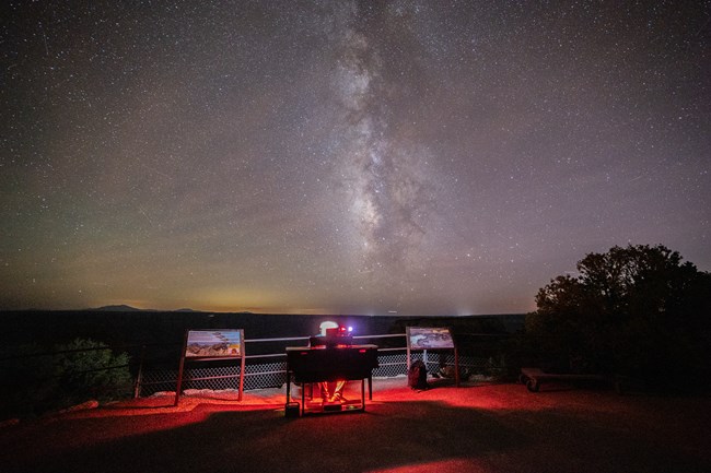 A man plays piano under the stars