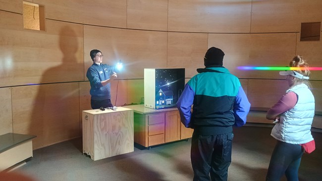 Man standing next to model house