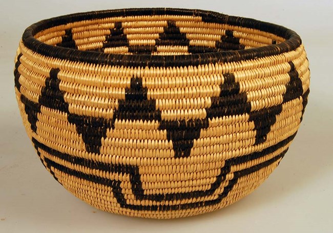 Traditional basket woven of black and tan twine