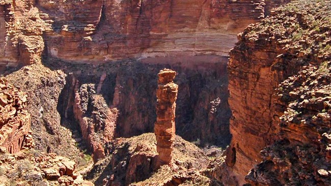 At Monument Creek - A single rock pillar centered on the Grand Canyon landscape.