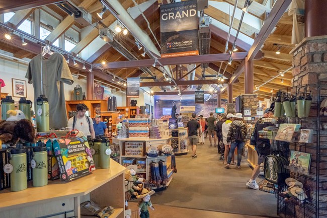 Books, gifts, and various photos displaed on shelves and cabinets.