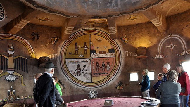 Visitors examining American Indian murals at Desert View Watchtower.