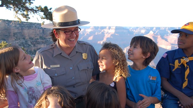 An educational ranger interacting with children.