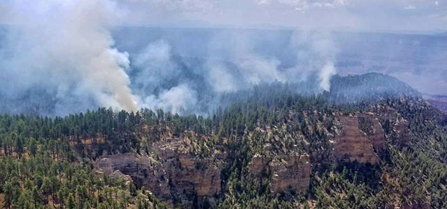 Smoke from several fires burning on a forested plateau above a canyon wall on July 24, 2018.