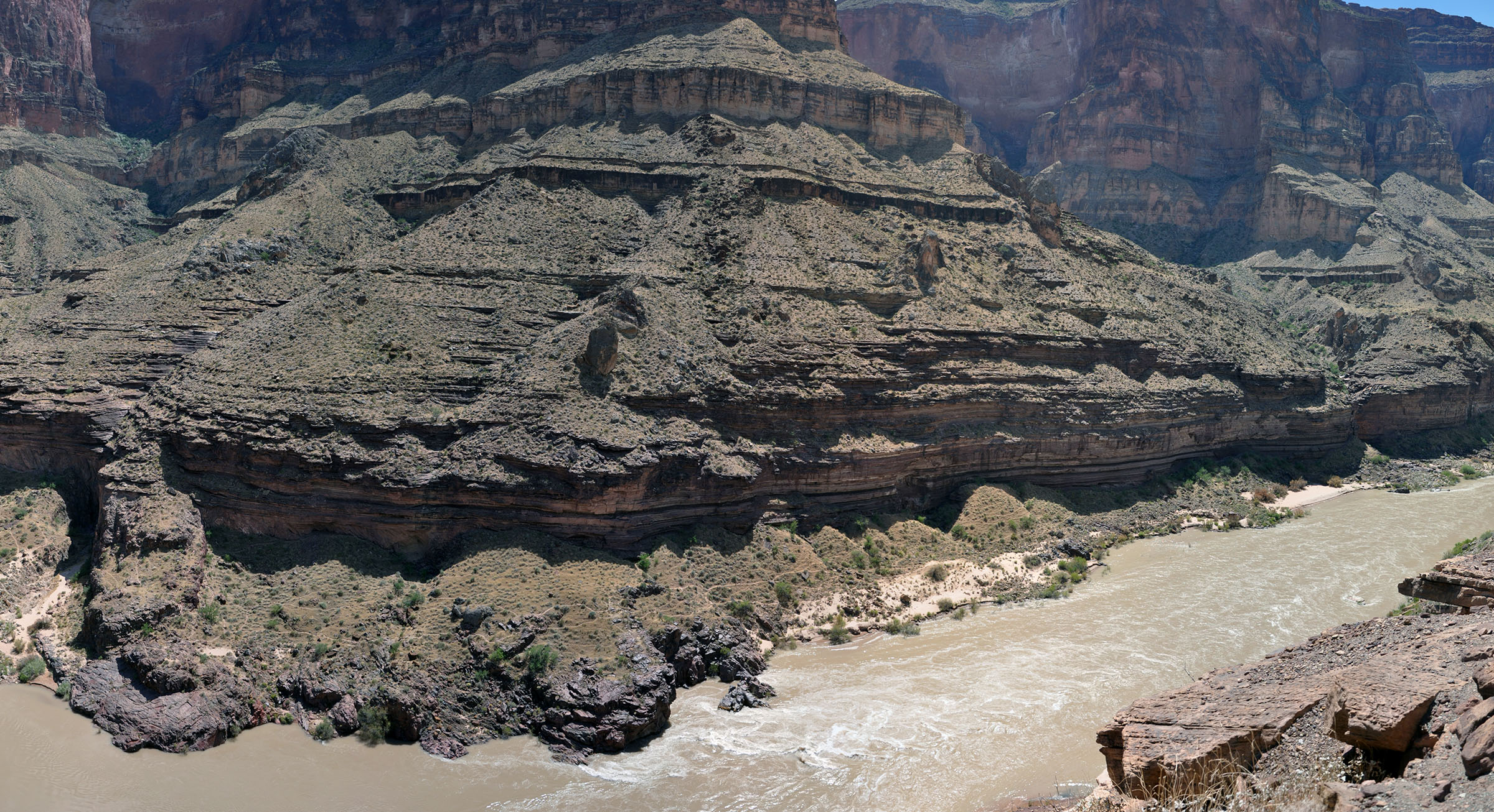 The Colorado River cuts through steep canyon walls