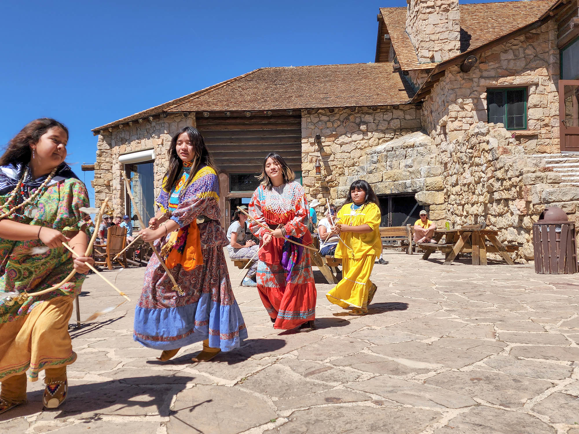 dancers in colorful garb on the rim of the Grand Canyon
