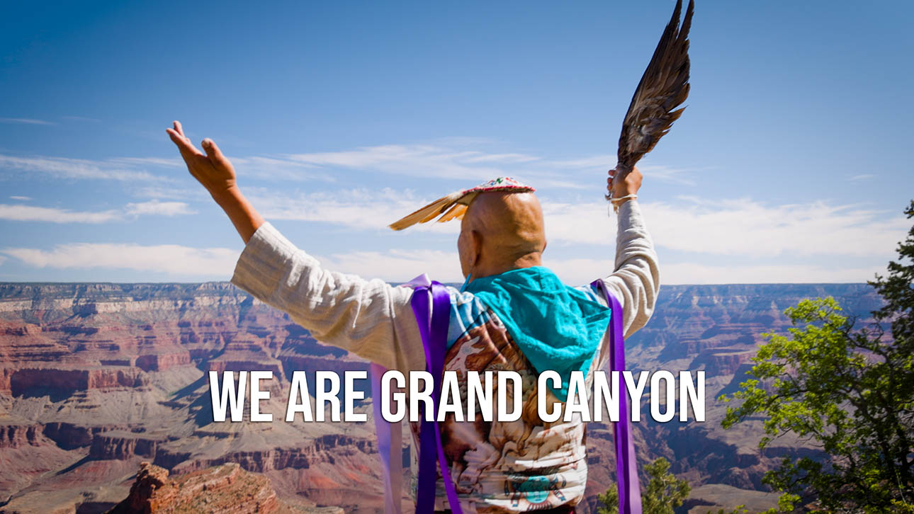 A tribal member stands at the rim of the canyon with the words 'We Are Grand Canyon' in text