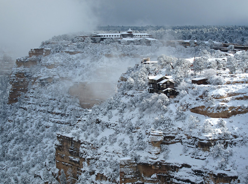 A snowy landscape in the South Rim Historic District. El Tovar and Kolb Studio can be seen in the background.
