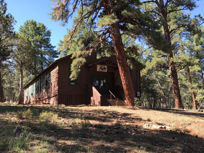 A photo of an historic log building that looks like a schoolhouse