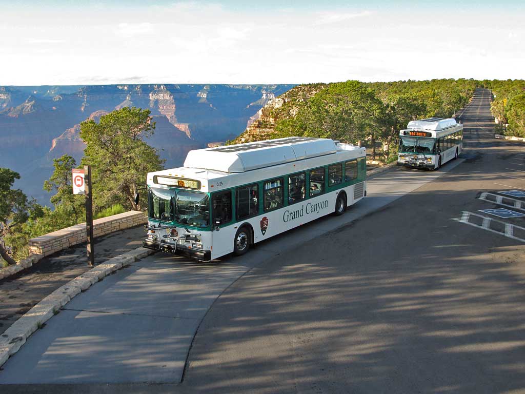 Two shuttle buses on the rim along Hermit Road.