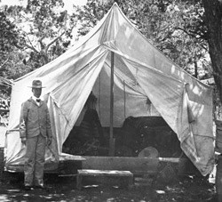 JOHN GEORGE VERKAMP STANDING BY  HIS TENT/CURIO STORE. 1897