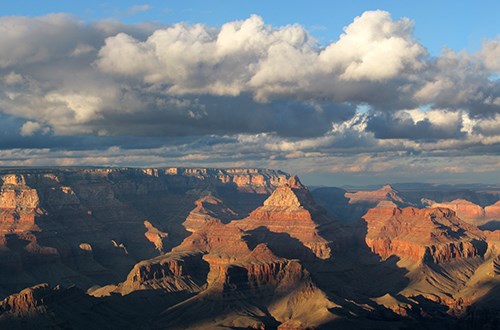 Grand Canyon landscape with clouds overhead.