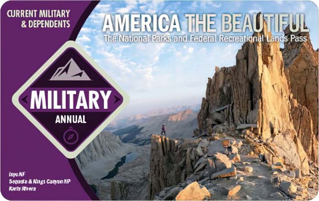 America the Beautiful 2023 Annual Military pass shows a backcountry trail ending at an overlook atop a jagged mountain peak, the words "military pass" are displayed within a purple diamond on the left.