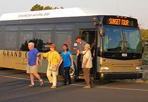 visitors stepping off of a tour bus