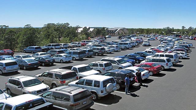 a parking lot filled to capacity with 4 rows of cars.