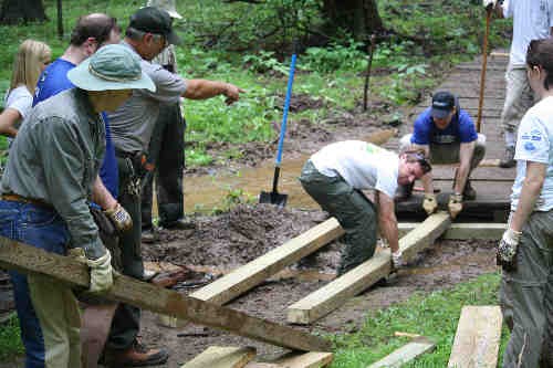 Volunteers working on Boardwalk repair in the forest of Greenbelt Park