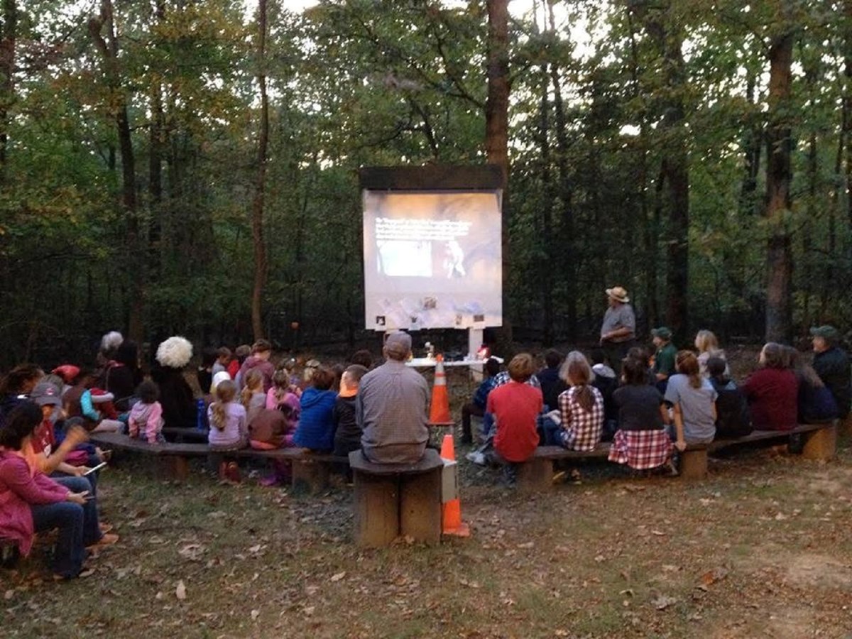 Campfire Program at Greenbelt Park with park ranger presenting a program before an audience of 50