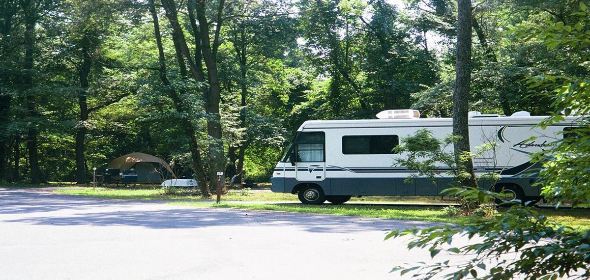 a picture of a RV and a tent in the Greenbelt Park campground
