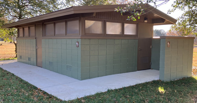 Square building with green sides and a brown roof.