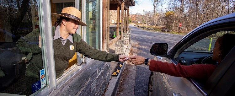 A Ranger collecting fees at a booth.