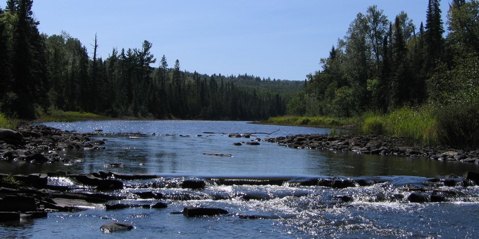Pigeon River flowing over rock area.