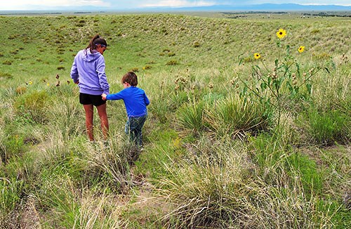 Two children in grasslands near Old Spanish Trail Route