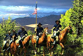 Black Buffalo Soldiers on Horseback with Dunes in Background