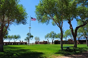 View of Fort Garland Historic Site with adobe buildings and US flag