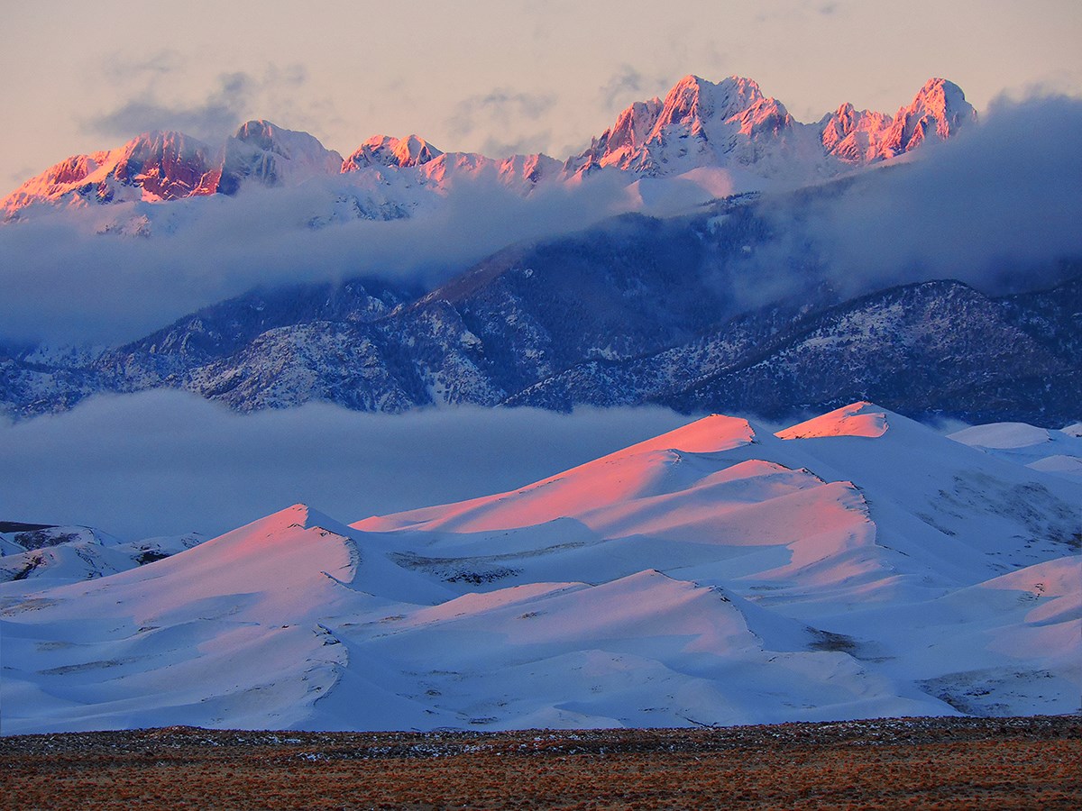 Snow covered Star Dune and Crestone Peaks at Sunset